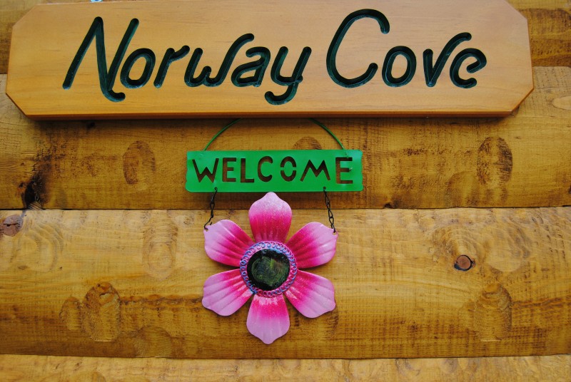 Norway Cove sign. Text: Norway Cove, Welcome.