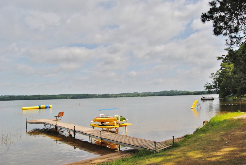Lake dock with kayaks and fishing chair