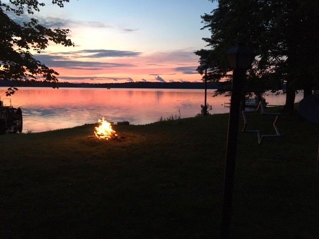 Birchwood firepit lit up at sunset.