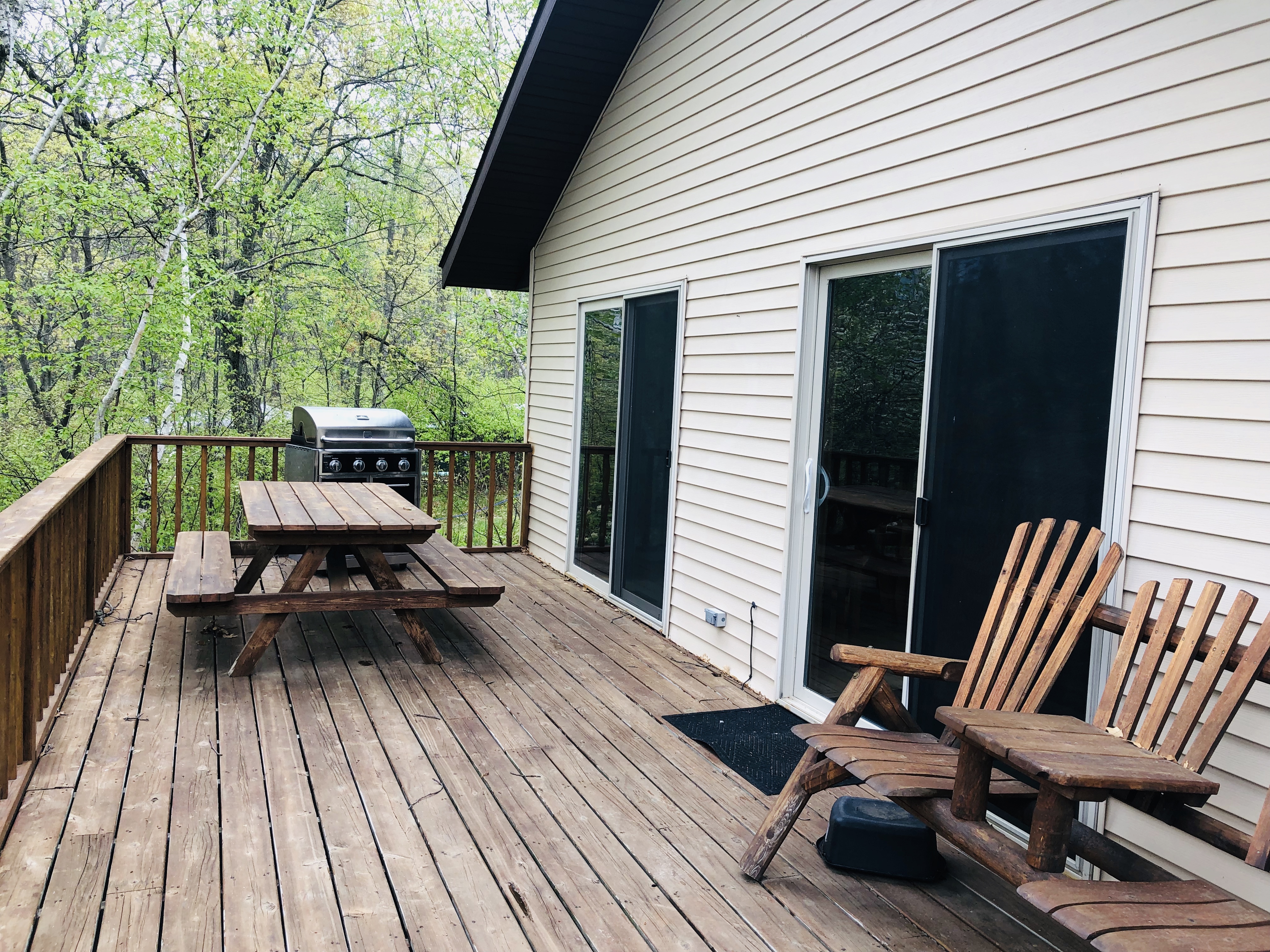 Virginian Pine patio with picnic table, Adirondack chairs and gas grill.