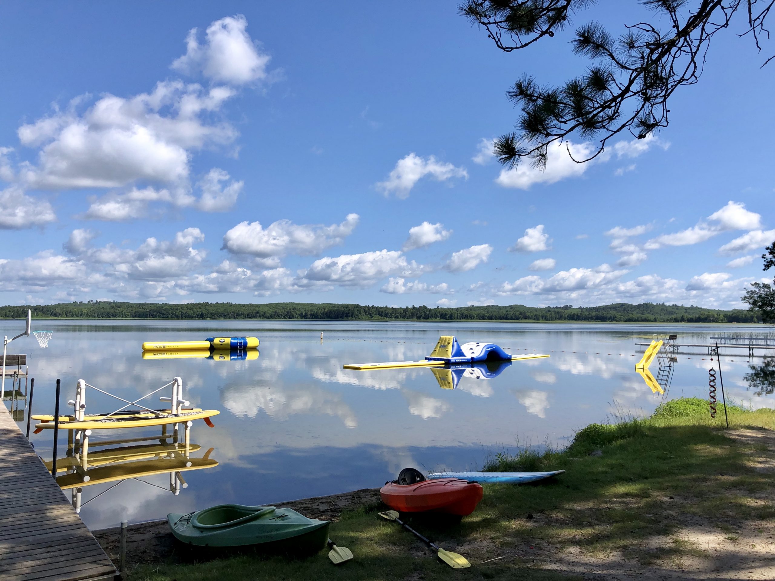 Lake with kayaks and water toys.