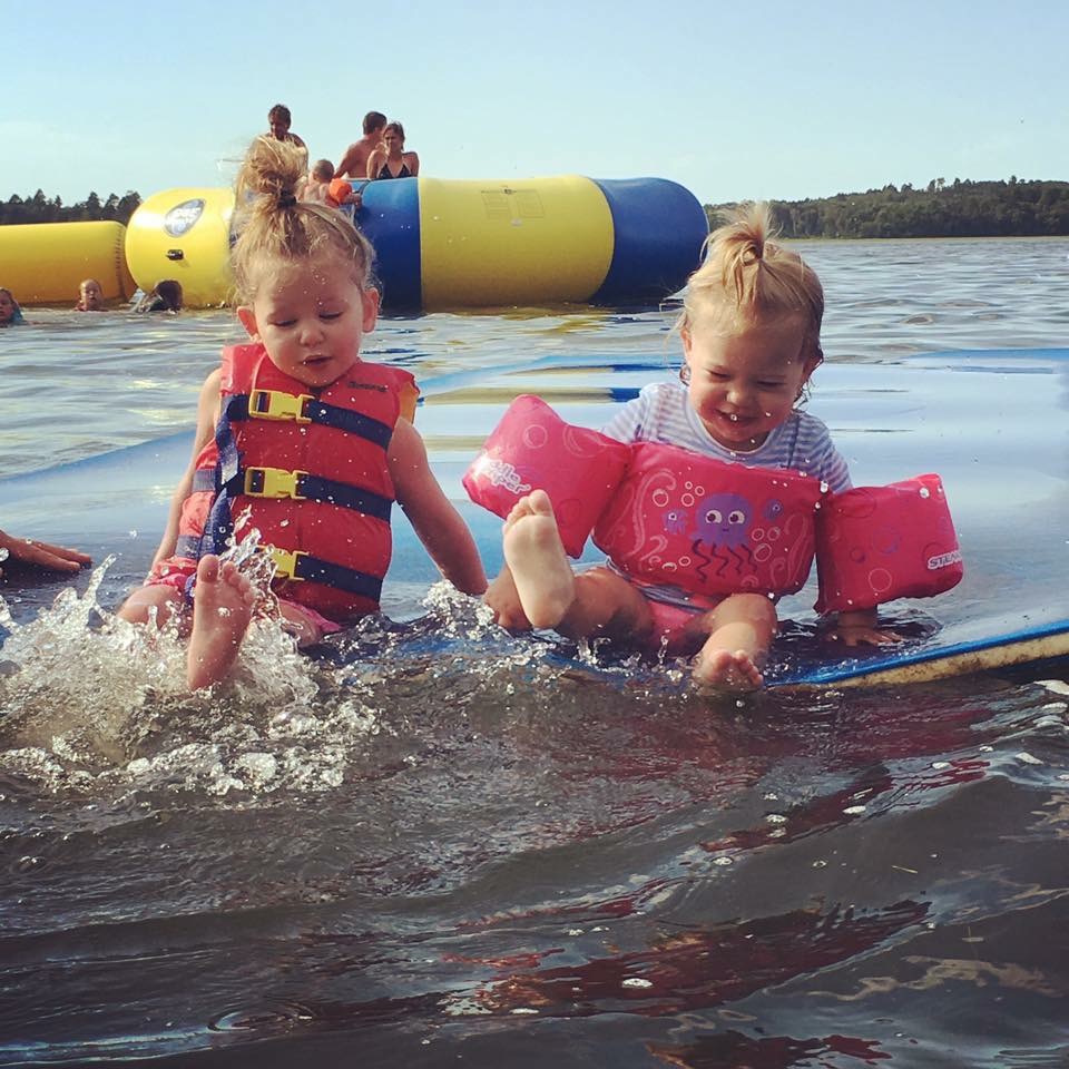Young girls splashing in lake.